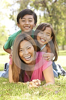 Mother And Children Enjoying Day In Park