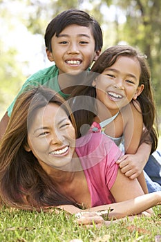 Mother And Children Enjoying Day In Park