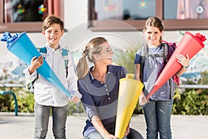 Mother and children on first day of school with candy cones