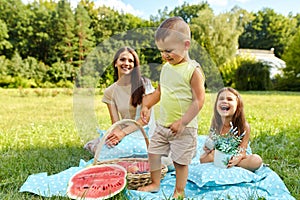 Mother With Children Having Fun In Park. Happy Family Outdoors