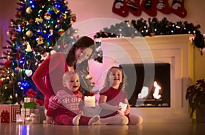 Mother and children at home on Christmas eve