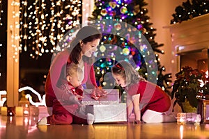 Mother and children at home on Christmas eve