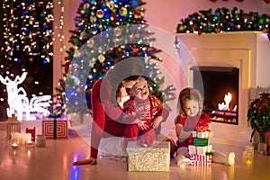 Mother and children at home on Christmas eve