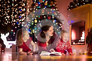 Mother and children at home on Christmas eve