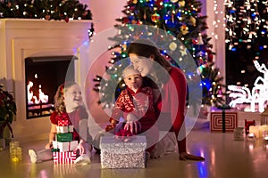 Mother and children at home on Christmas eve