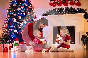 Mother and children at home on Christmas eve