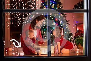 Mother and children at home on Christmas eve