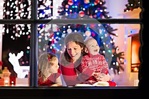 Mother and children at home on Christmas eve