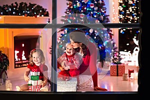 Mother and children at home on Christmas eve