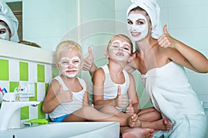 Mother and children make a face mask in the morning.The boys joke with mom. Beauty treatments for the skin