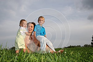 Mother with children on meadow