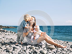 Mother with children outdoors on ocean on Tenerife, Spain.