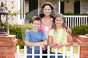 Mother and children outside home