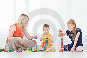 Mother and children playing with blocks