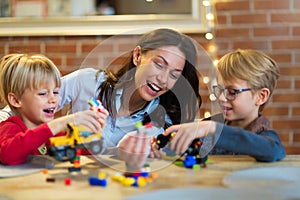 Mother and children playing with blocks