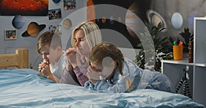 Mother and children praying together