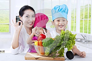 Mother and children preparing vegetables