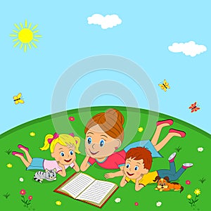 Mother and children are reading book on a meadow