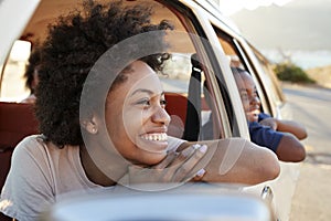 Mother And Children Relaxing In Car During Road Trip