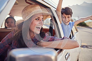 Mother And Children Relaxing In Car During Road Trip