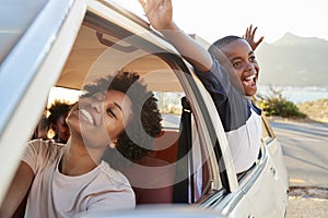 Mother And Children Relaxing In Car During Road Trip