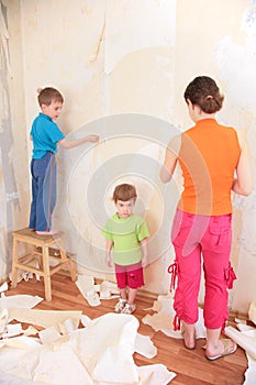 Mother with children remove old wallpapers from wa photo