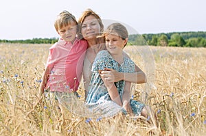 Mother and children in the rye field