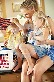 Mother And Children Sorting Laundry photo