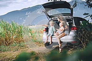 Mother and children watching on countryside. Family in road trip