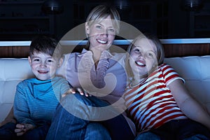 Mother And Children Watching Programme On TV Tog photo