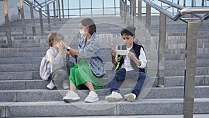 Mother and children wearing face mask going to school during coronavirus outbreak. Safety mask for illness prevention