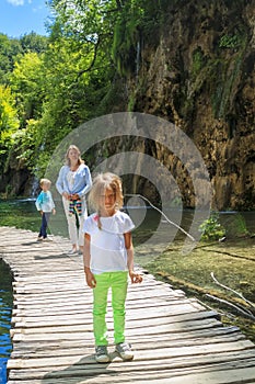 mother and children on a wooden path going through the untouched