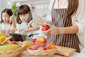 Mother and childs happy to preparing healthy food at home kitchen from vegetables and fruit