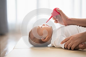 Mother cleaning the nose for baby