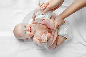 Mother cleaning up and wipes body and leg baby by wet tissue. Cleaning wipe, pure, clean. happy emotions of newborn baby