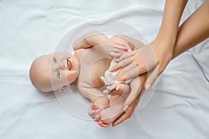 Mother cleaning up and wipes body and leg baby by wet tissue. Cleaning wipe, pure, clean. happy emotions of newborn baby