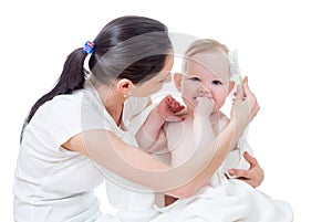 Mother combing baby after bathing