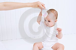 Mother is combing beautiful baby`s hair