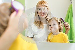 Mother is combing child hair after bathing