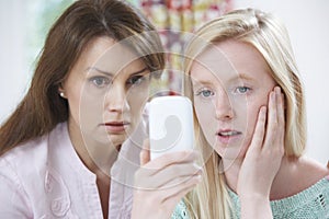 Mother Comforting Daughter Being Bullied By Text Message