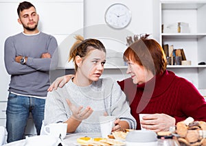 Mother comforting daughter after discord with husband