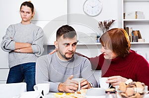 Mother comforting son after discord with wife