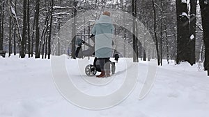 A mother comforts a crying baby while walking in a winter snow-ins