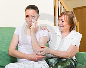 Mother comforts daughter at home