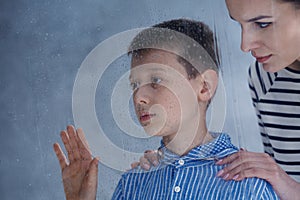 Mother comforts her autistic son
