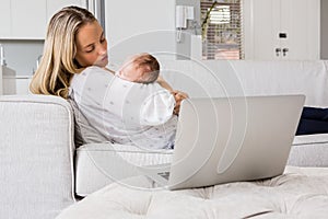 Mother consoling her baby in living room