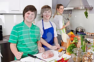 Mother cooking with her sons in the kitchen - family life.