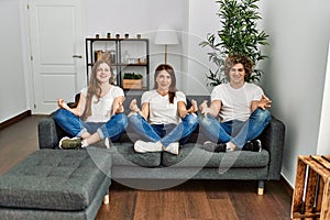 Mother and couple smiling confident doing yoga exercise at home