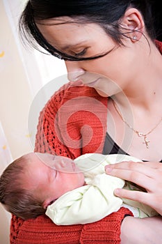 Mother cradling baby girl photo