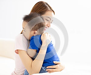 Mother Cuddling Baby son At Home